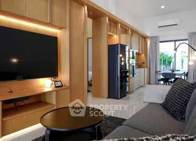 Modern living room with open kitchen, sleek design and natural light