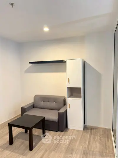 Modern living room with minimalist furniture and wooden flooring