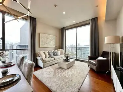 Spacious modern living room with large windows and city view, featuring elegant decor and cozy seating area.