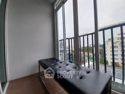 Stylish balcony with modern seating and city view, perfect for relaxation and enjoying the skyline.