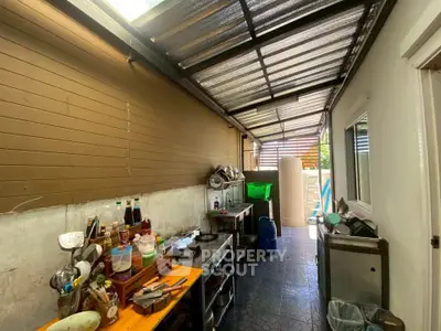 Spacious outdoor kitchen with covered roof and modern appliances