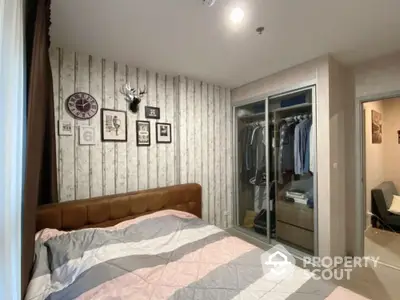 Cozy bedroom with stylish decor and spacious closet in modern apartment.