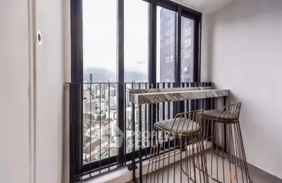 Modern balcony with city view and stylish bar stools in high-rise apartment.