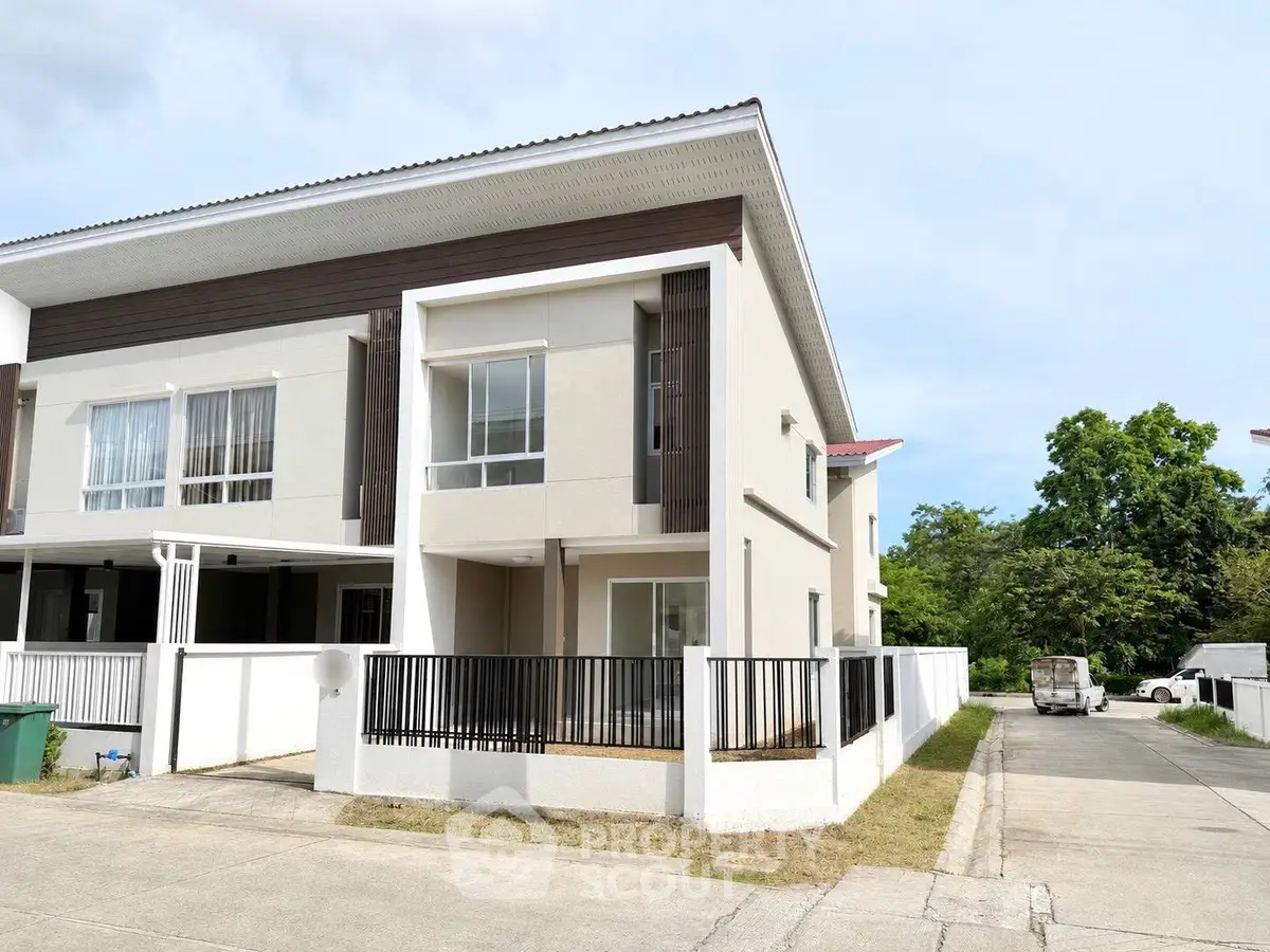 Modern two-story townhouse with sleek design and spacious outdoor area in a serene neighborhood.