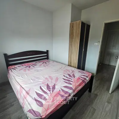Cozy bedroom with modern wooden wardrobe and stylish bed in a minimalist design.