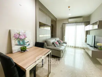 Modern living room with elegant decor and natural light, featuring a cozy sofa and stylish dining area.