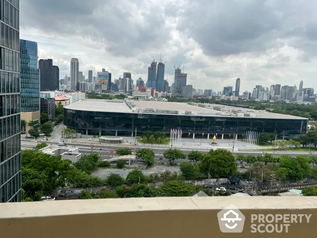 Expansive city skyline view from a high-rise balcony showcasing urban living at its finest, with lush greenery and modern architecture.