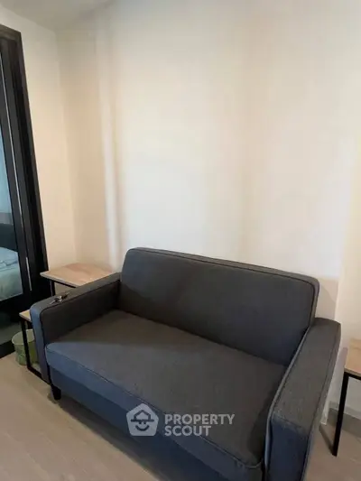 Modern living room with sleek gray sofa and minimalist decor
