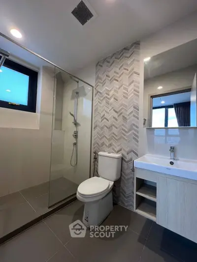 Modern bathroom with glass shower and stylish tile design