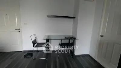 Minimalist study room with glass desk and modern chair on sleek flooring