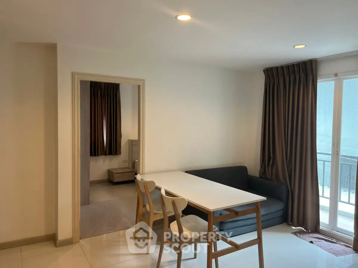 Modern apartment interior with dining area and balcony view