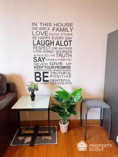 Cozy living room corner with motivational wall art and modern decor.