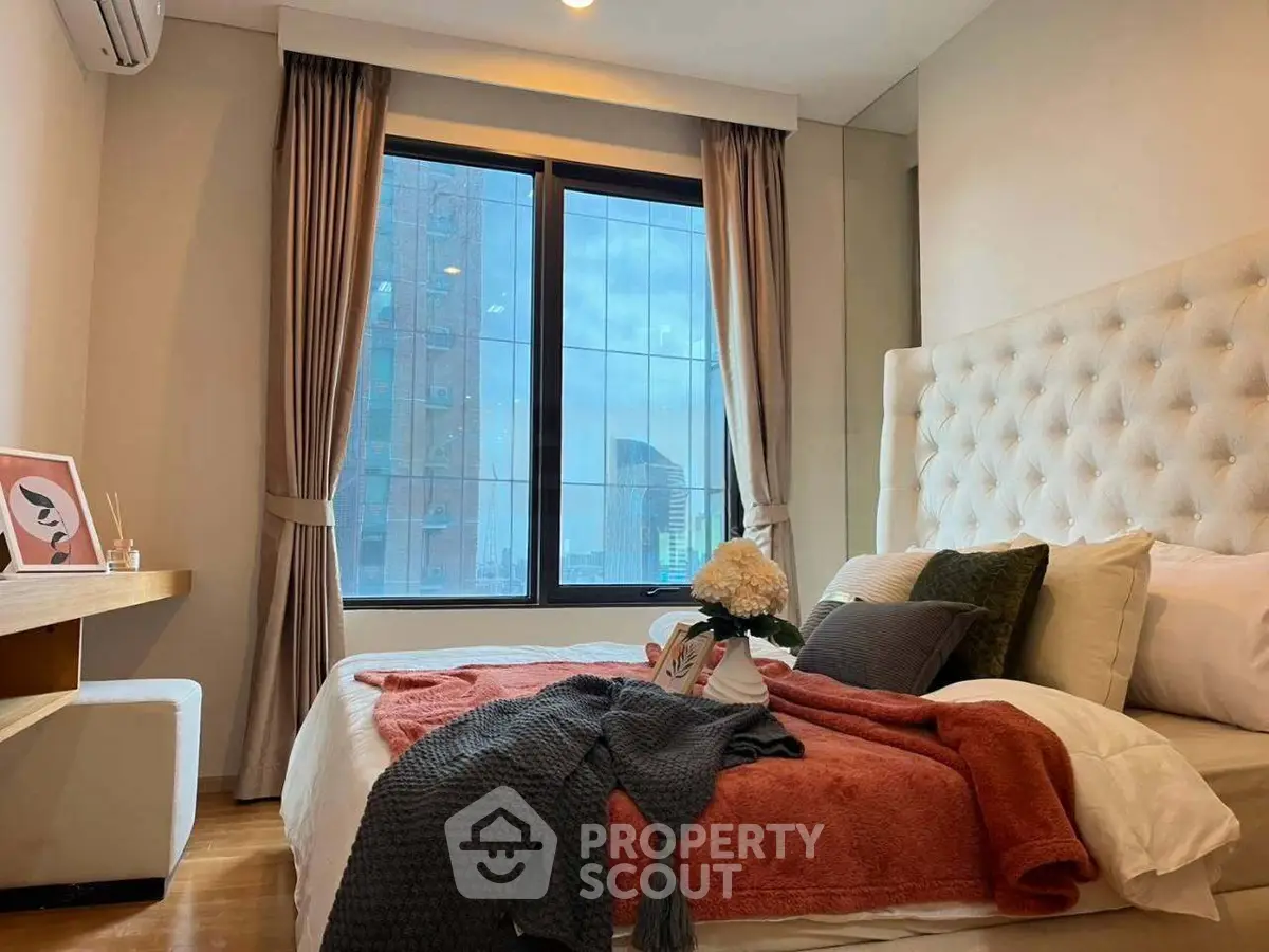 Cozy bedroom with large window and modern decor in urban apartment