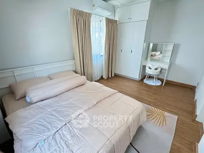 Cozy bedroom with modern decor, featuring a comfortable bed, stylish vanity, and ample natural light.