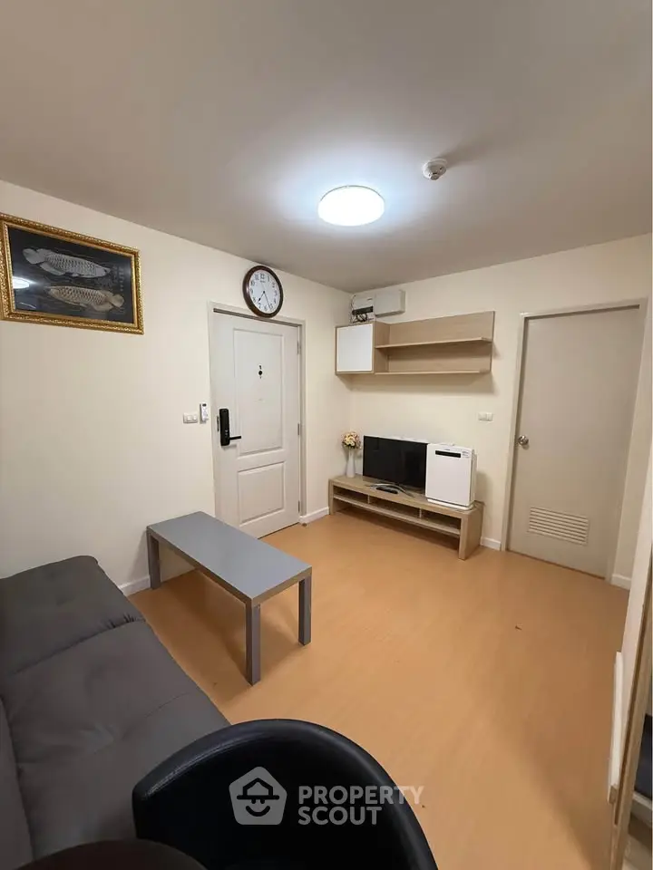 Cozy living room with modern decor and ample natural light, perfect for relaxation and entertainment.