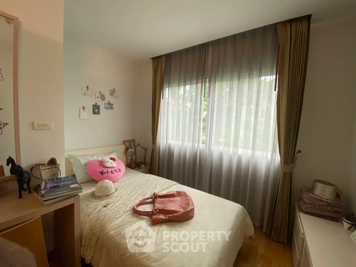 Cozy bedroom with natural light and stylish decor, perfect for relaxation and comfort.