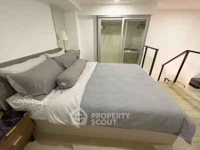 Modern bedroom with stylish decor and walk-in closet in a contemporary apartment.