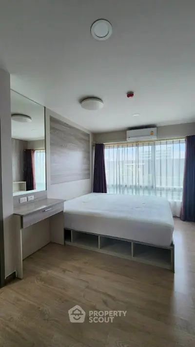Spacious bedroom with modern design and large windows for natural light