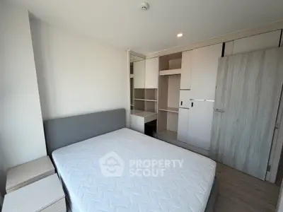 Modern bedroom with stylish built-in wardrobe and cozy bed in a bright apartment.