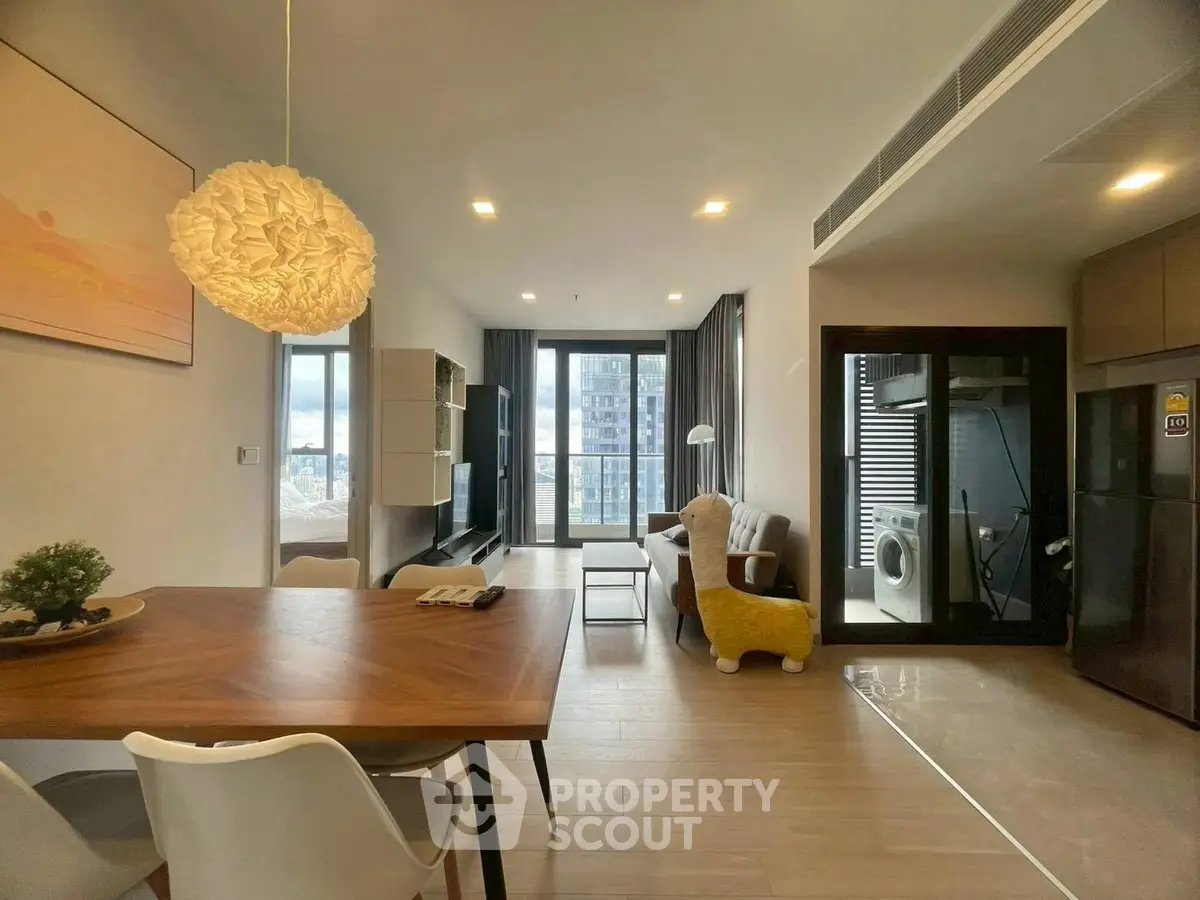 Modern open-plan living room with dining area and balcony view
