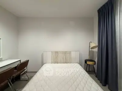 Cozy minimalist bedroom with modern furniture and soft lighting, perfect for relaxation and comfort.