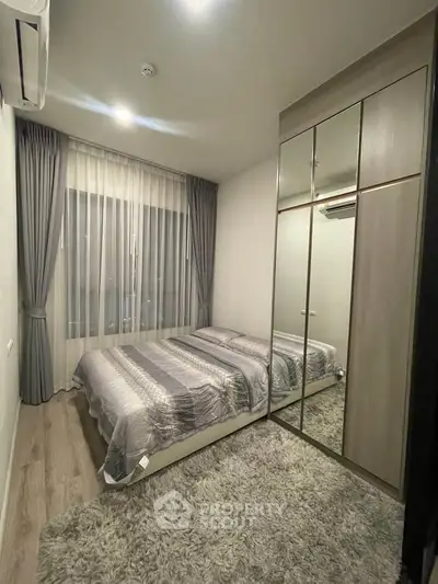 Cozy bedroom with modern decor and mirrored wardrobe
