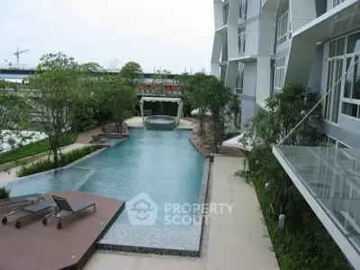 Luxurious modern apartment with stunning pool and lush greenery
