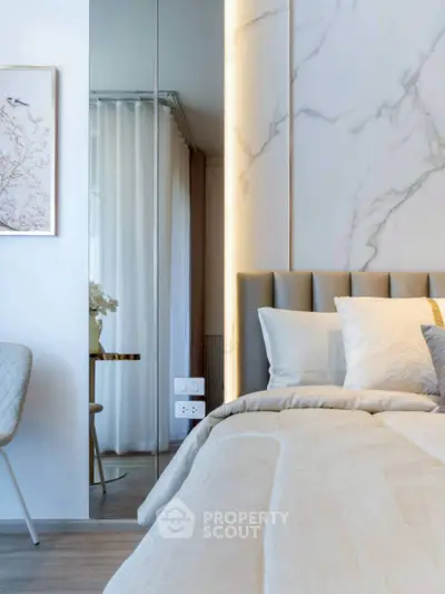 Luxurious modern bedroom with elegant marble wall and plush bedding