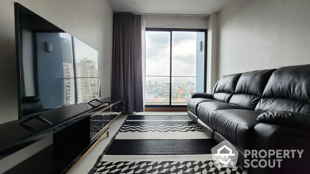 Modern living room with city view, sleek black furniture, and large window for natural light.