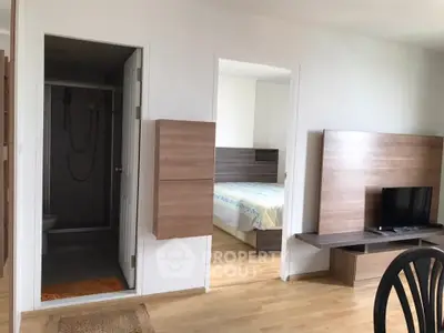 Modern apartment interior with bedroom and living area featuring wooden accents and natural light.