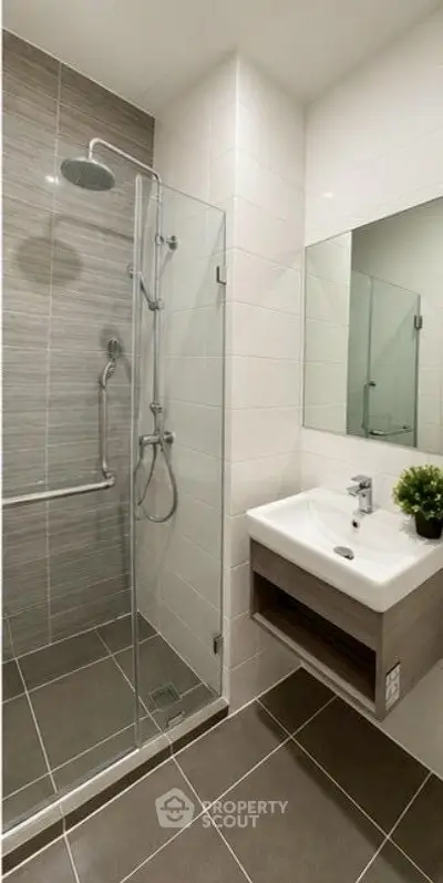 Modern bathroom with glass shower and sleek sink design