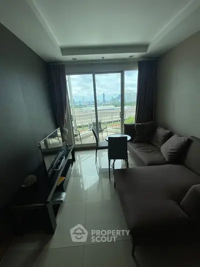 Cozy living room with city view, featuring modern sofa and TV setup.