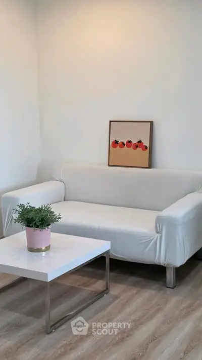 Modern living room with white sofa, stylish coffee table, and minimalist decor.