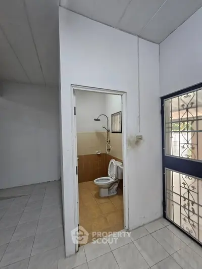 Compact bathroom with shower and toilet in a minimalist home interior