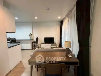 Modern living room with stylish furniture and open kitchen layout
