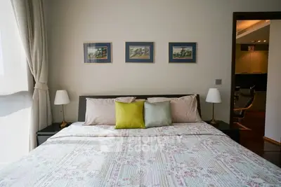 Cozy bedroom with stylish decor and natural light, perfect for relaxation.