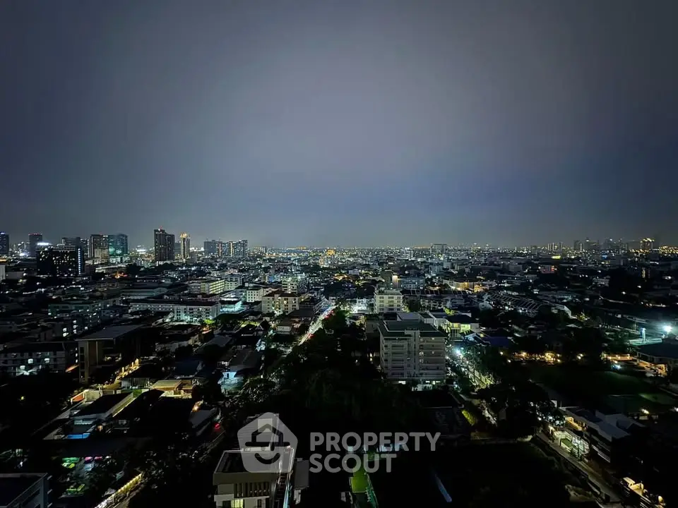 Stunning cityscape view from high-rise building at night with twinkling city lights.