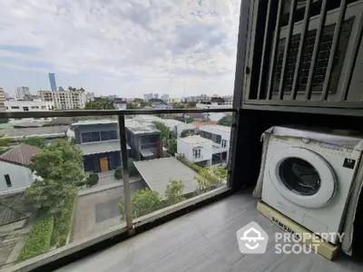 Modern balcony with washing machine and stunning city view