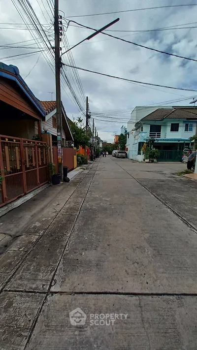 Charming residential street with diverse architecture and lush greenery.