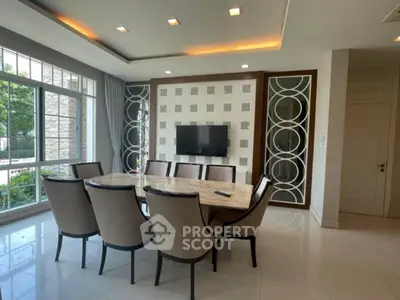 Elegant dining room with modern decor and large windows for natural light
