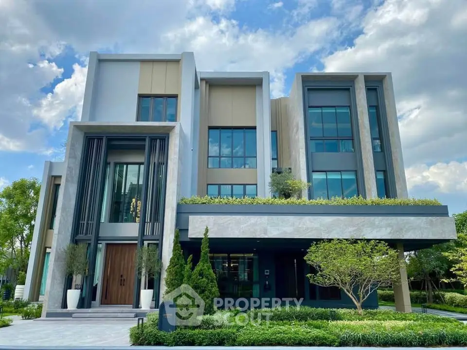 Luxurious modern house with sleek design and lush greenery, perfect for upscale living.