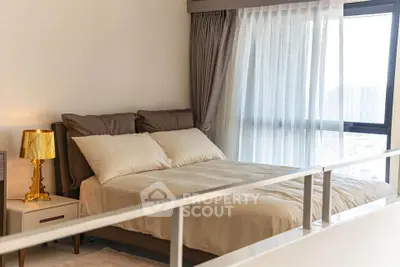 Luxurious bedroom with elegant decor and large window offering city views.