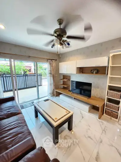 Spacious living room with modern decor and large balcony access