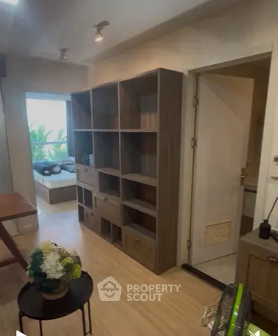Cozy living room with wooden shelving and natural light