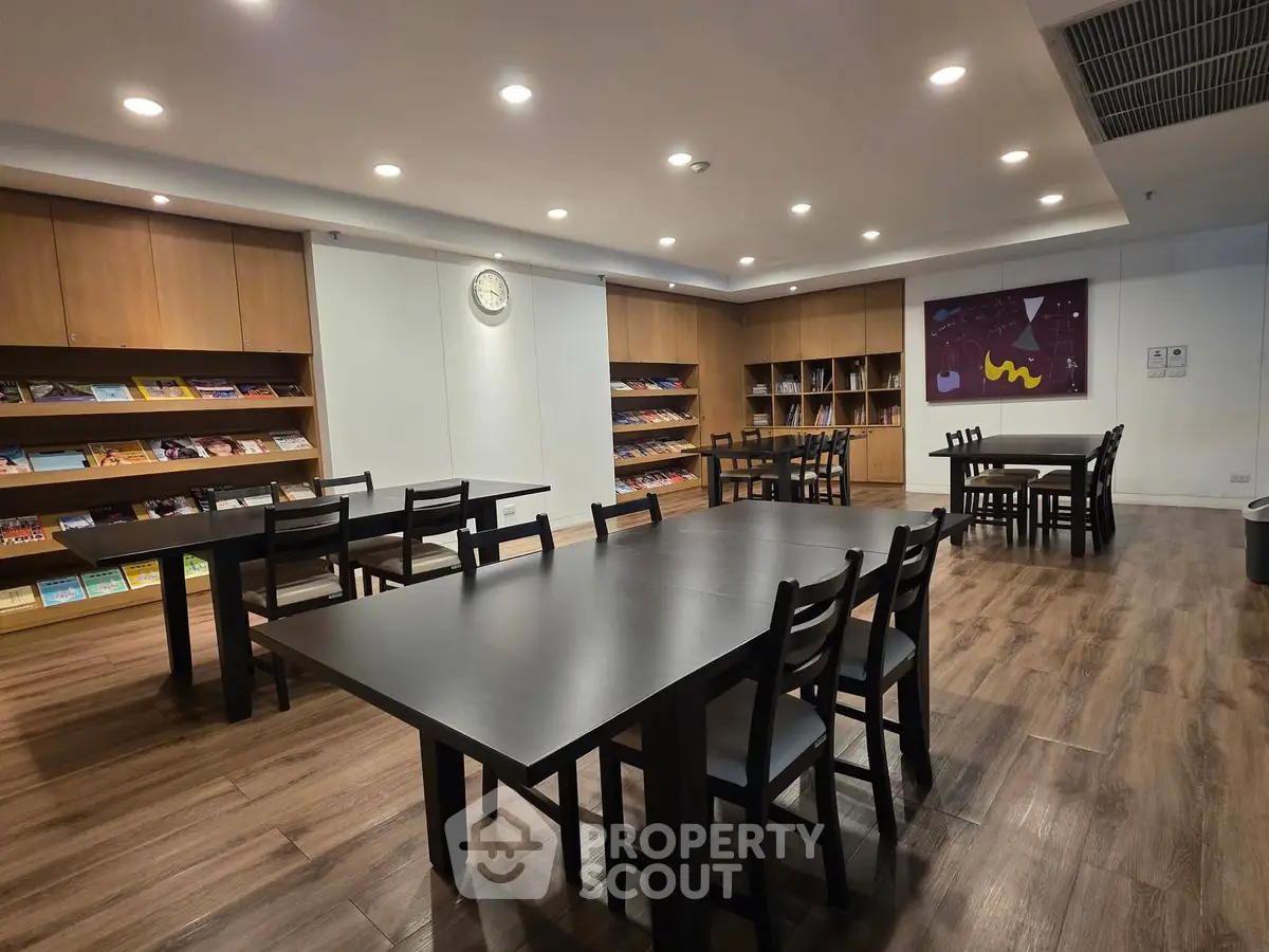 Spacious library with modern wooden flooring and ample seating