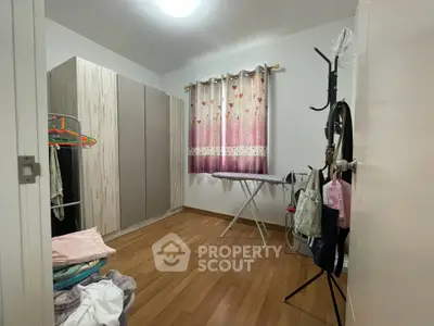 Cozy storage room with wooden flooring and ample closet space, perfect for organizing your belongings.