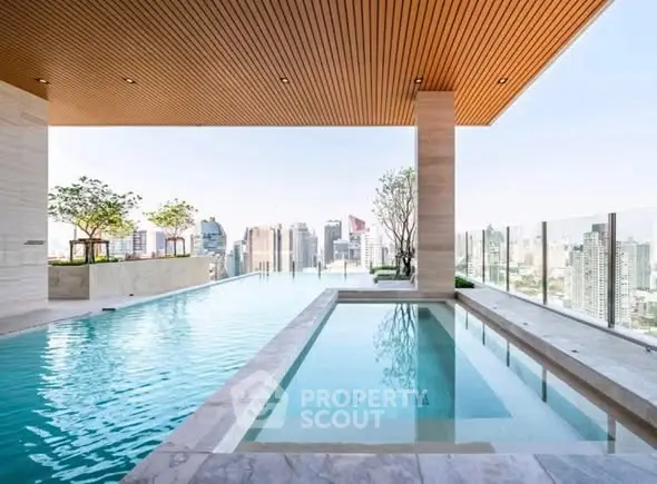 Luxurious rooftop pool with stunning city skyline view, perfect for relaxation and leisure in urban living.