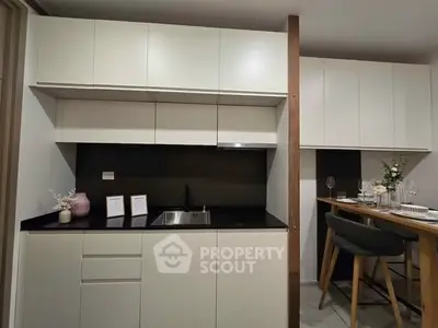 Modern kitchen with sleek cabinetry and dining area, perfect for urban living.