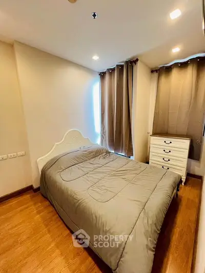 Cozy bedroom with elegant decor and natural light, featuring a comfortable bed and stylish furnishings.
