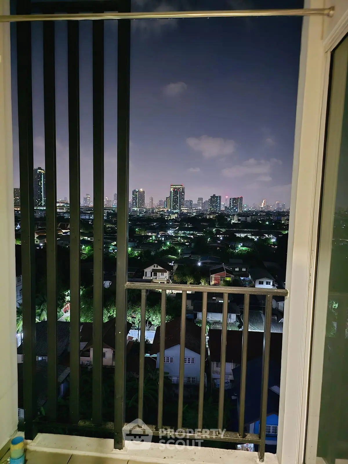Stunning city skyline view from a high-rise balcony at night, perfect for urban living enthusiasts.
